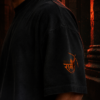 Close up of the right sleeve on the black ombré t-shirt displaying the orange Lord Rama bow graphic and Jai Shri Ram text.
